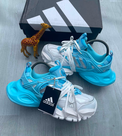 Adidas chunky mesh sneaker in sky blue and white with sculptural rubber sole, coiled heel detail, and three-stripe branding — Swingdot Luxe