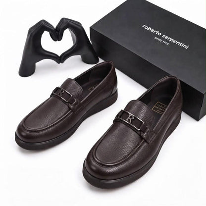 Pair of dark brown Roberto Serpentini men's loafers with metallic R detail beside the branded box