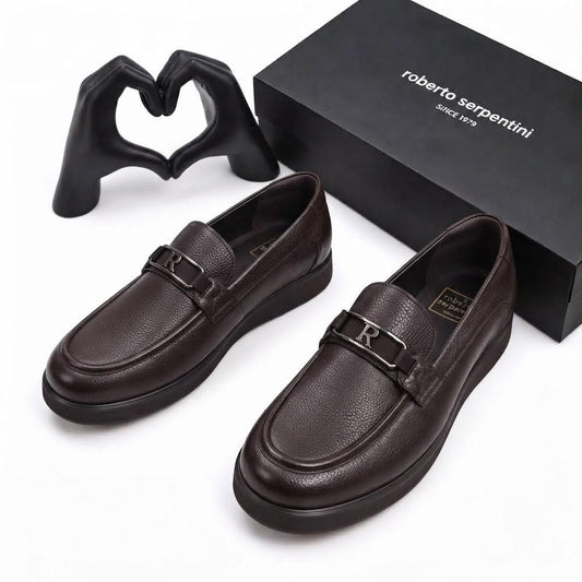Pair of dark brown Roberto Serpentini men's loafers with metallic R detail beside the branded box