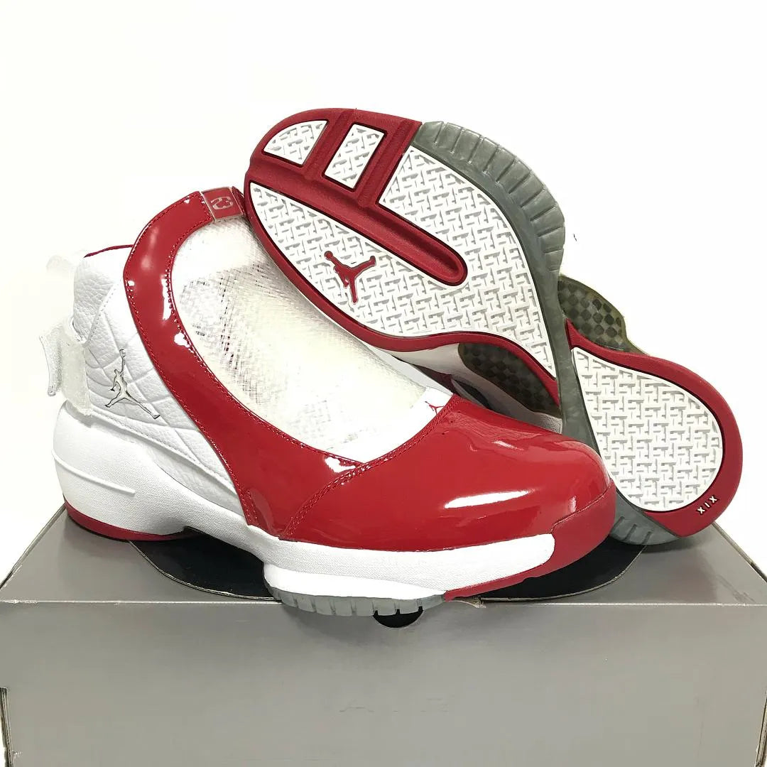 Nike Air Jordan 19 OG high-top sneakers in white and varsity red with glossy red patent leather toe cap, midfoot cage overlay, silver Jumpman hardware, and red white grey outsole with XIX stamp — 100% authentic collector Jordan sneakers
