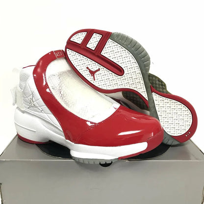 Nike Air Jordan 19 OG high-top sneakers in white and varsity red with glossy red patent leather toe cap, midfoot cage overlay, silver Jumpman hardware, and red white grey outsole with XIX stamp — 100% authentic collector Jordan sneakers