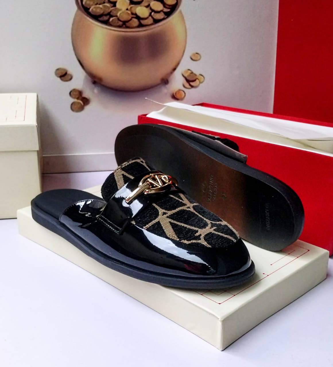 Valentino Garavani black patent leather and Toile Iconographe jacquard mule slides with gold VLogo hardware, smooth black leather insole, and black rubber sole displayed against Valentino red box — 100% authentic men's luxury slides