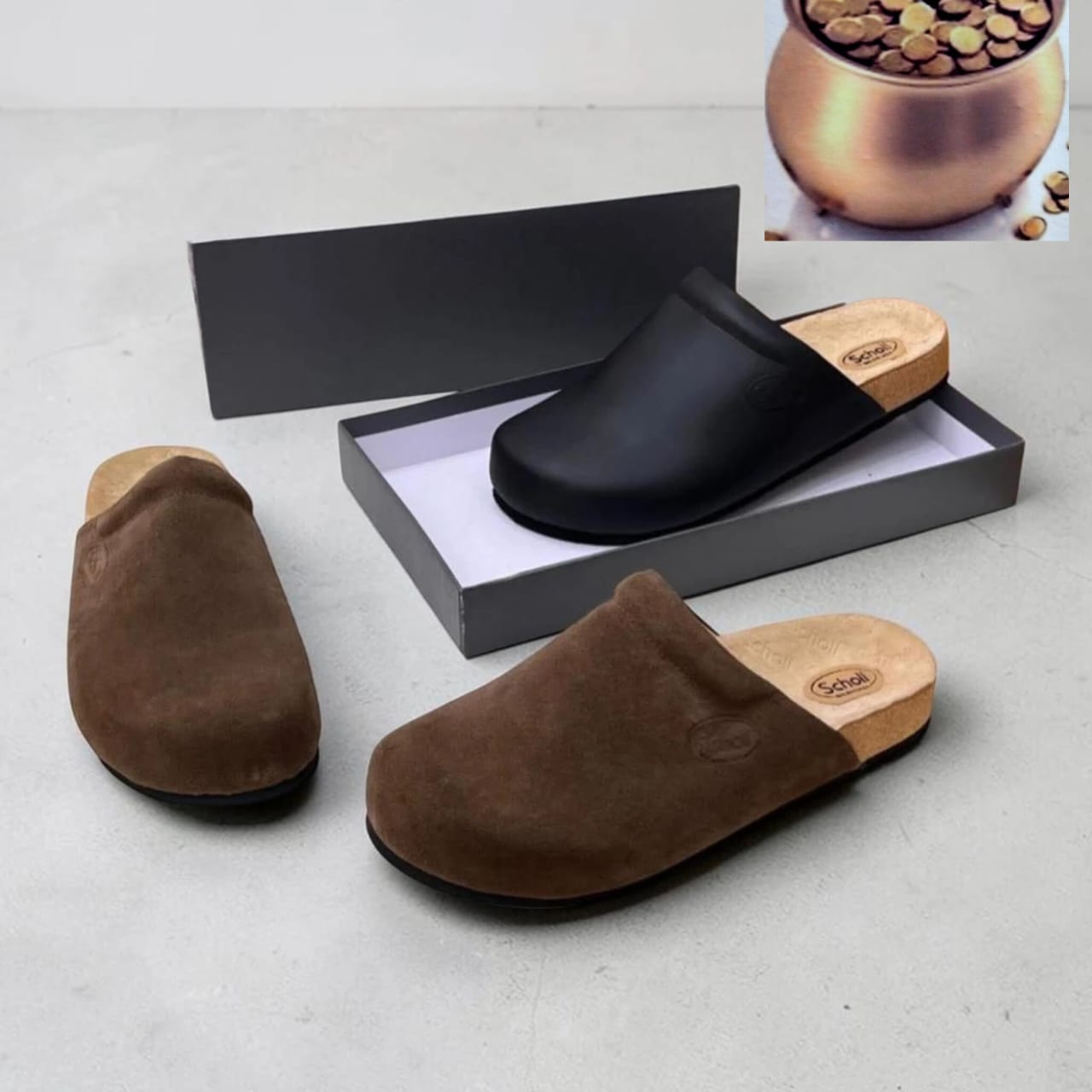 Scholl closed-toe mule clogs in black smooth leather and dark brown suede, both with natural wood-effect orthopedic footbed and embossed Scholl logo medallion, displayed on grey box — 100% authentic men's luxury clogs