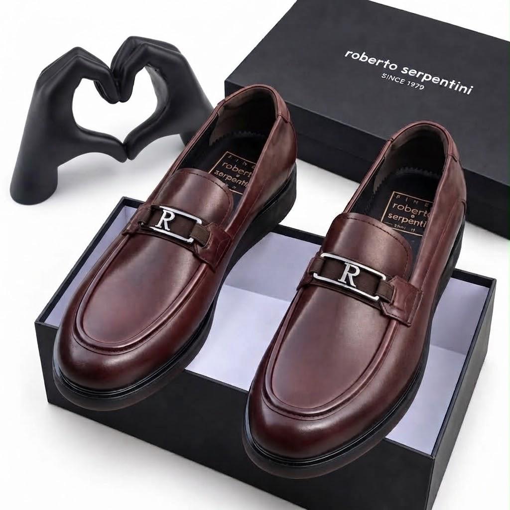 Pair of burgundy-brown Roberto Serpentini men's loafers with metallic R detail displayed on a branded box
