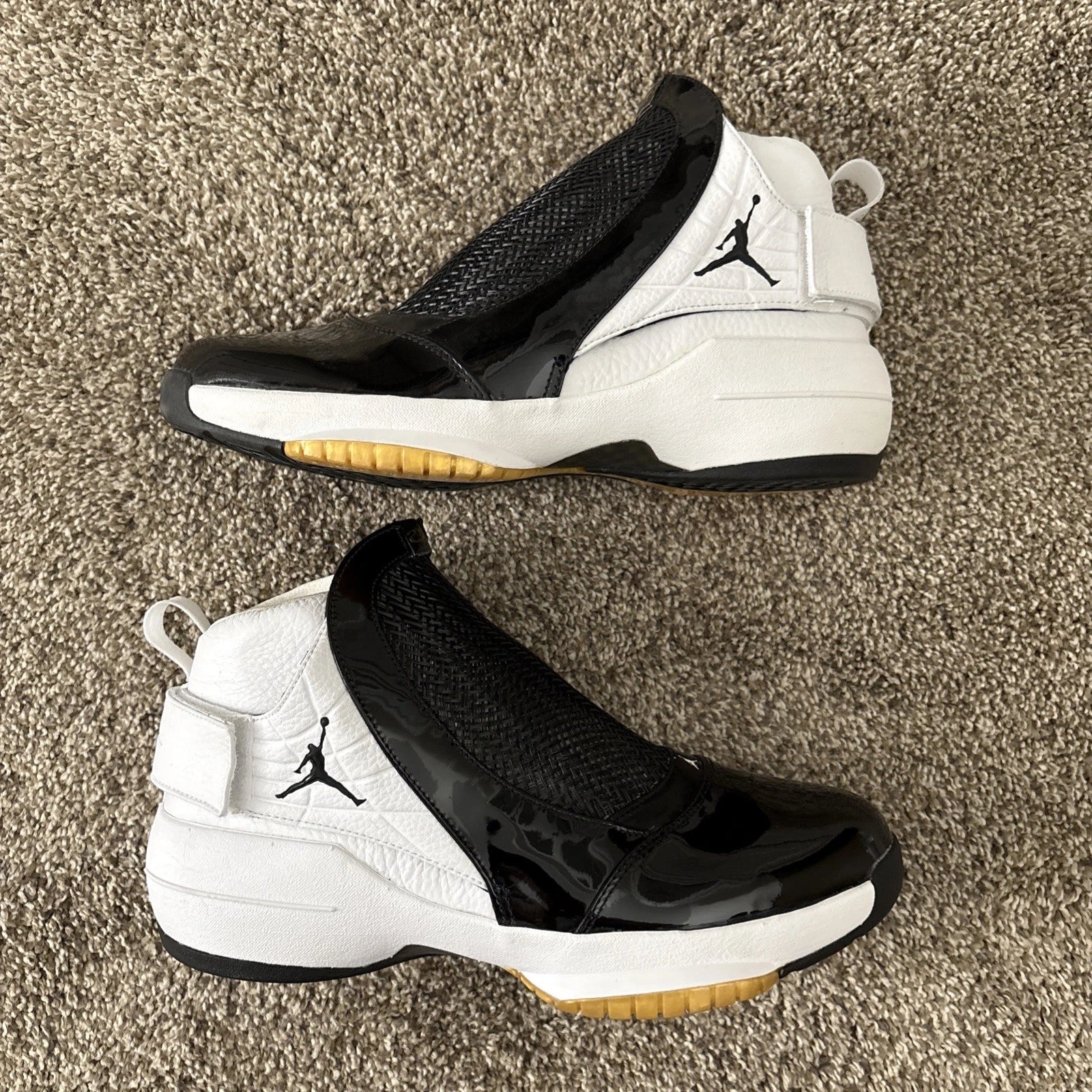 Nike Air Jordan 19 OG high-top sneakers in white and black Tuxedo colourway with patent leather toe cap, carbon fibre midfoot cage, black Jumpman logo, and translucent gum outsole — 100% authentic collector Jordan sneakers