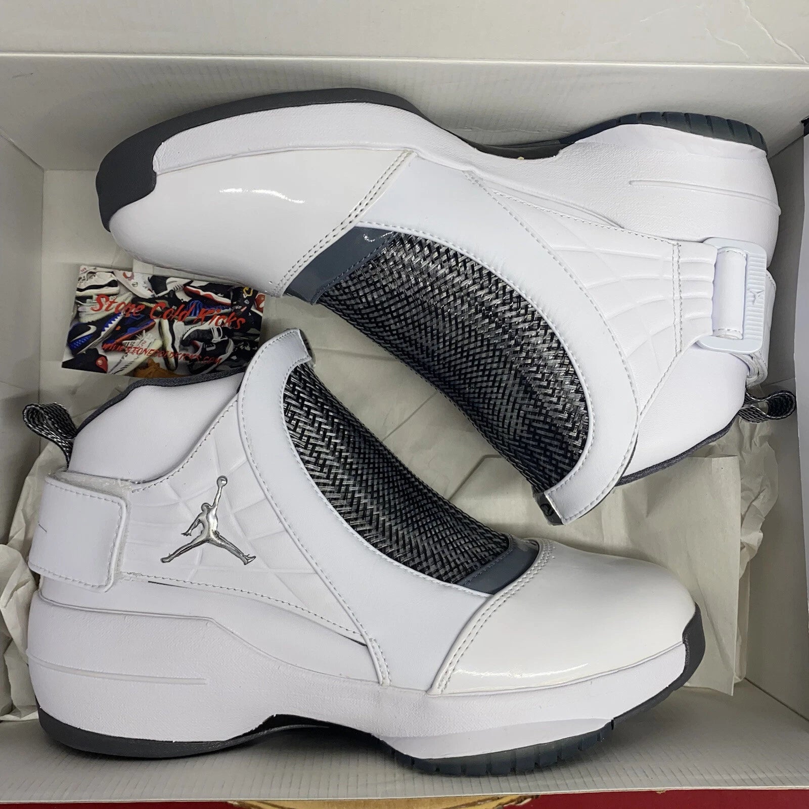 Nike Air Jordan 19 OG high-top sneakers in white and flint grey with carbon fibre midfoot cage, silver Jumpman logo, and quick-lace strap system — 100% authentic collector Jordan sneakers